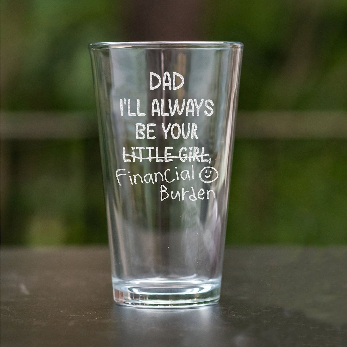 Engraved custom whiskey glass with playful 'Dad, Financial Burden' message.