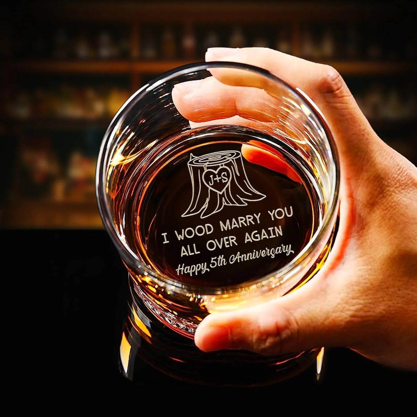 Anniversary gift for couple featuring custom whiskey glass with engraved message I Wood Marry You Again