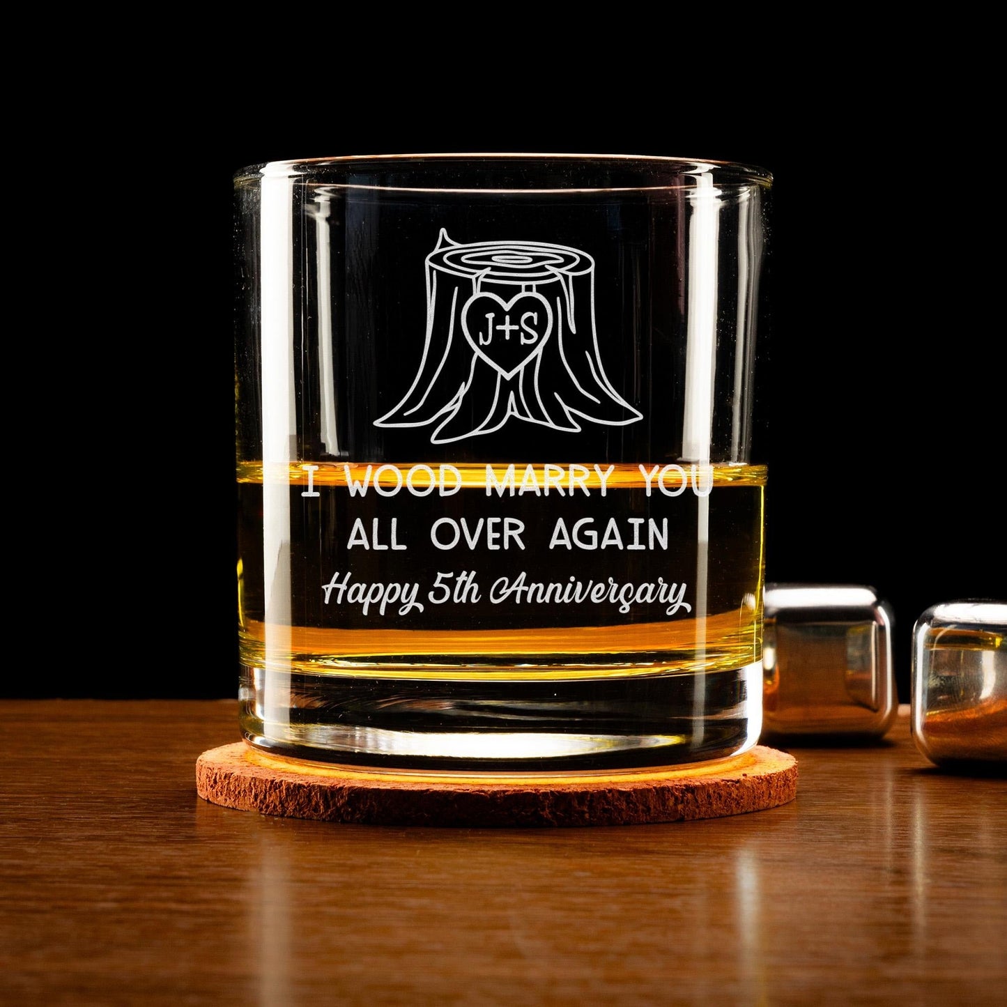 Wood anniversary gifts like engraved whiskey glass with I Wood Marry You Again message