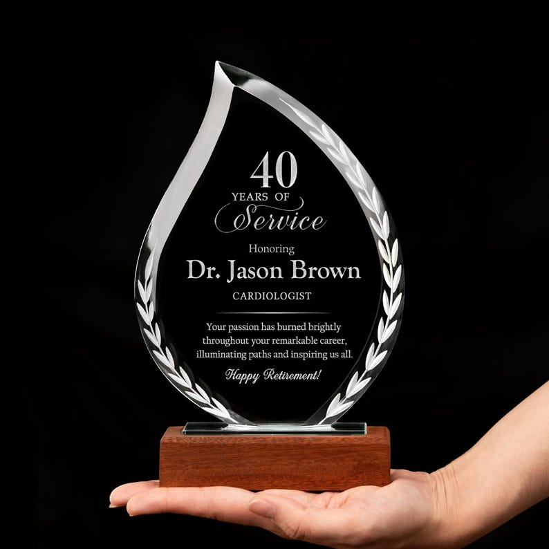 A close-up of a custom employee dedication glass trophy, the Custom 40 Years Of Service Flame Award, for a 40th year work anniversary.