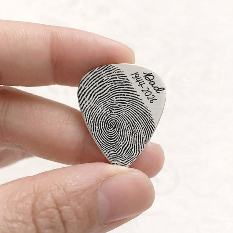 Unique thumbprint guitar pick, offering a heartfelt and personalized way to honor a cherished memory.