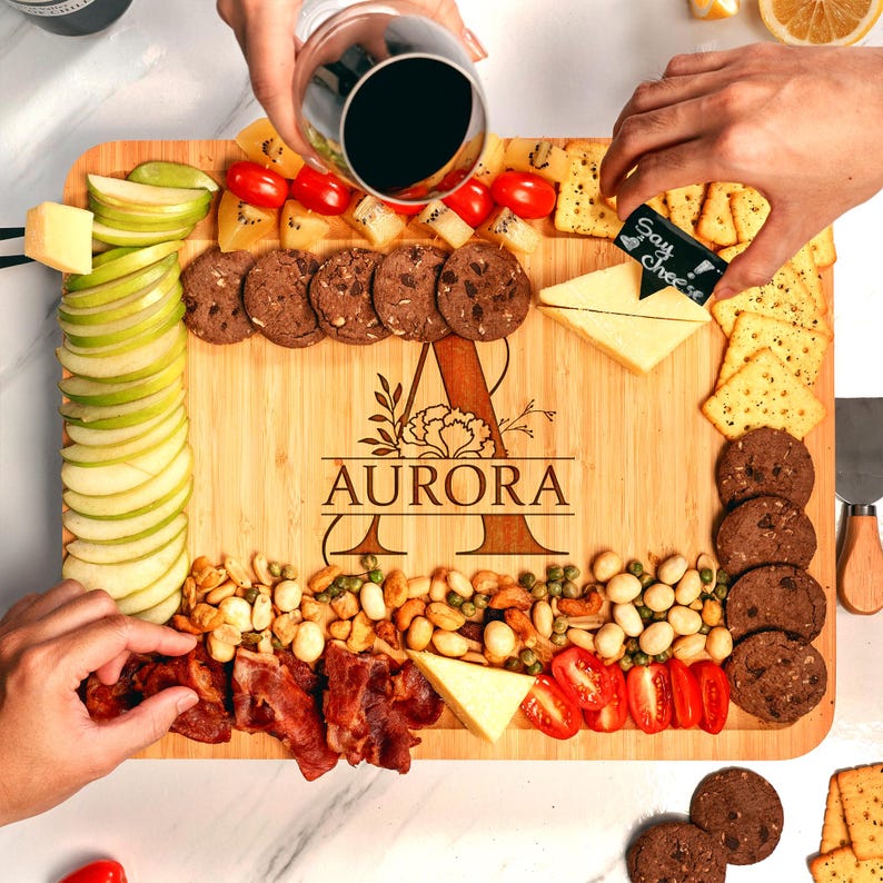 An engraved Personalized Monogrammed Bamboo Charcuterie Board, an ideal personalized cheese board gift set for couples.