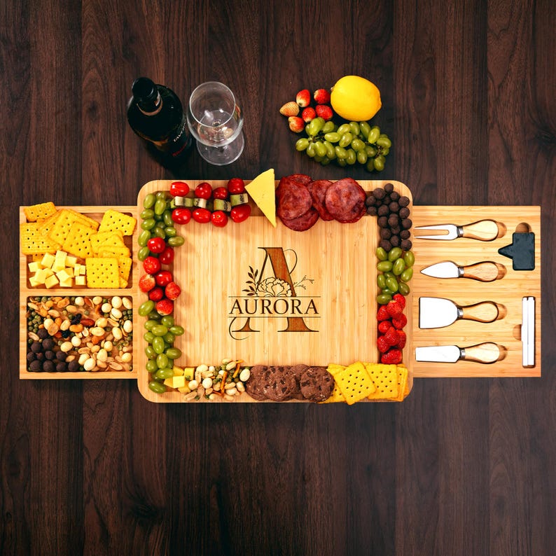 A close-up of a charcuterie board with a beautiful monogram, crafted from sustainable premium bamboo.