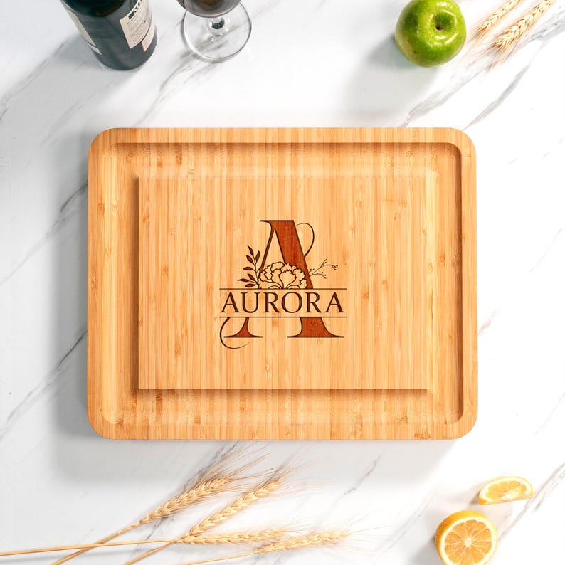 Custom initial cheese board made from high-quality bamboo, a thoughtful and personalized wedding gift.