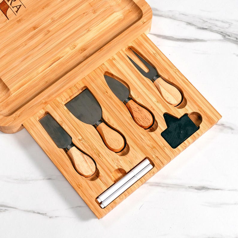 This monogram cheese board set, a Personalized Monogrammed Bamboo Charcuterie Board, is an ideal housewarming present.