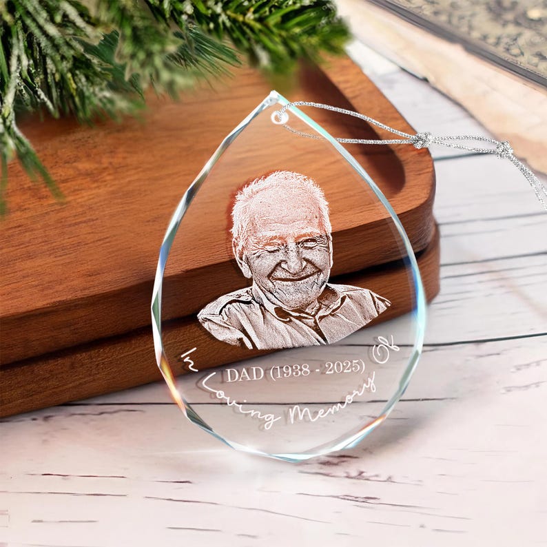 A thoughtful funeral gift idea, the Personalized Photo Memorial Teardrop Glass Ornament is a beautiful glass teardrop Christmas ornament.