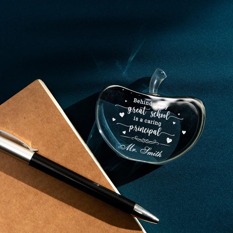 A close-up of a personalized glass paperweight, a thoughtful custom Christmas gift for a principal.