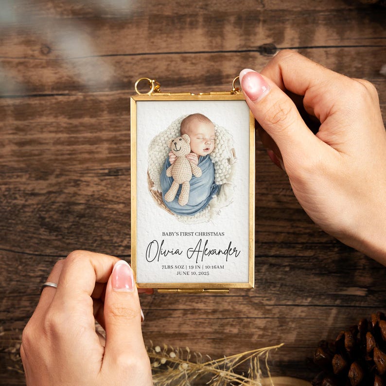 A beautiful custom hand painted Christmas ornament, the Personalized Watercolor Baby's First Christmas Frame Ornament is a cherished newborn Christmas ornament and gift for new parents.