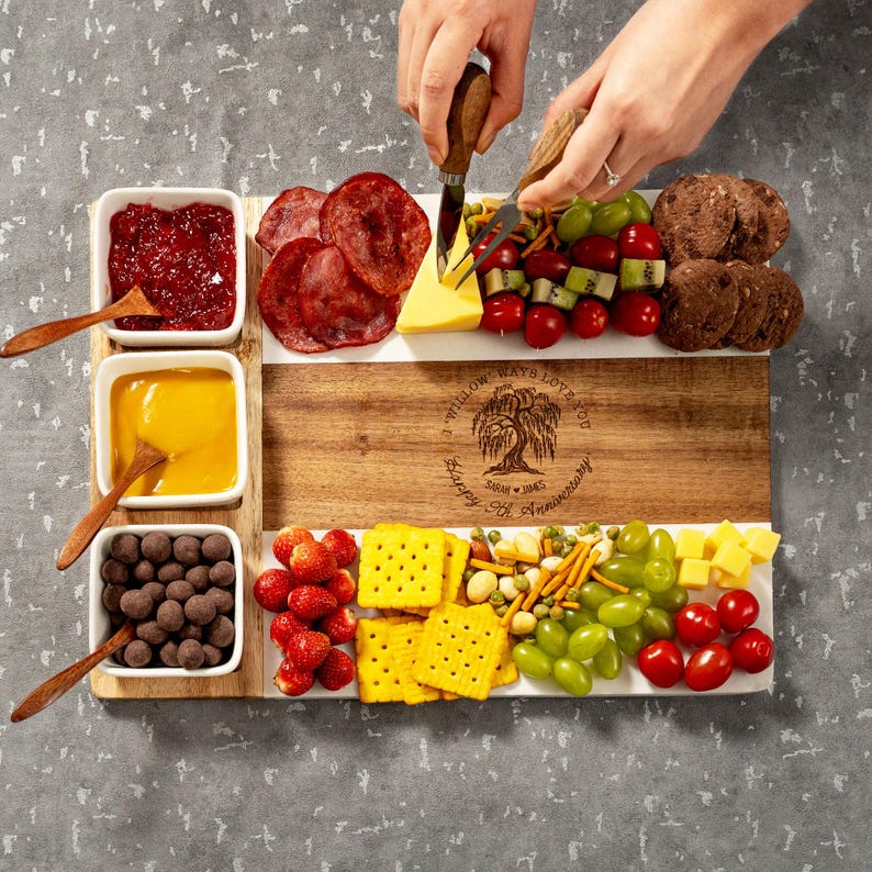 A close-up of a personalized marble and wood cheese board, the perfect engraved gift for a 9th wedding anniversary.