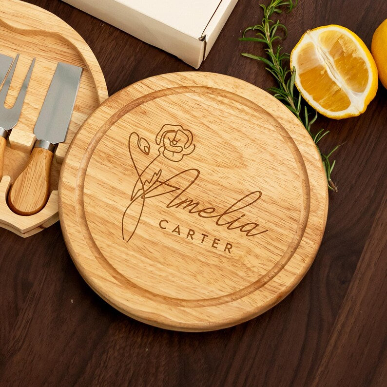 An elegant personalized round cheese board featuring a custom name and birth month flower for a unique touch.