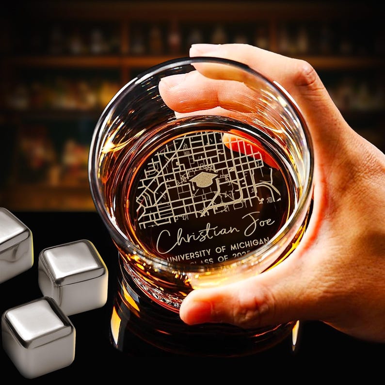 This custom engraved whiskey glass features a detailed college map, making it a perfect memento for grads.