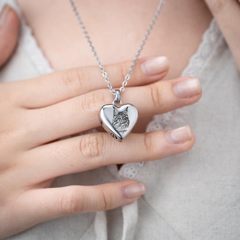 A close-up of the Personalized Cat Photo Heart Urn Necklace, a heartfelt sympathy gift for a grieving cat owner.