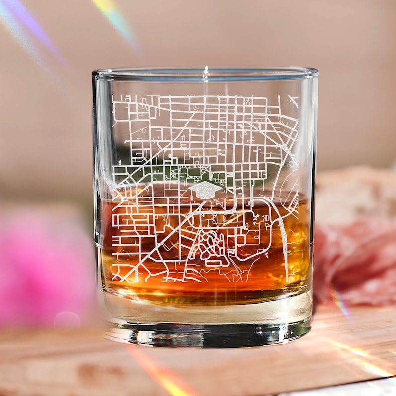 A high-quality engraved whiskey glass showcasing your alma mater, ideal for personalized whiskey glassware.