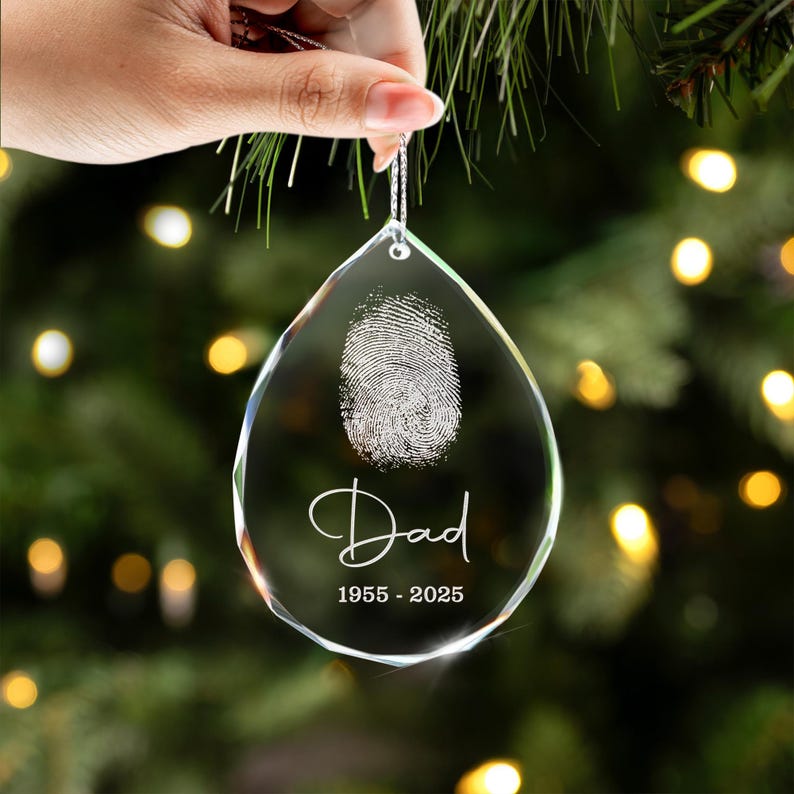 A teardrop ornament and sympathy gift, the Personalized Fingerprint Dad Remembrance Teardrop Glass Ornament honors a father's memory.