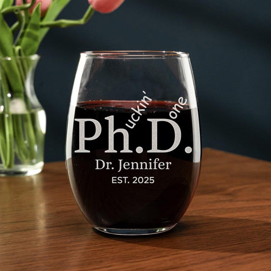 Personalized Funny PhD Graduation Wine Glass for the Class of 2026, a unique and witty doctoral graduation gift.