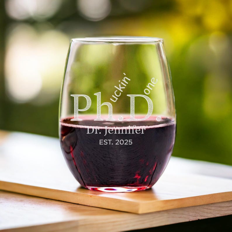 This custom wine glass features a humorous PhD design, making it one of the best college graduation gifts for new grads.