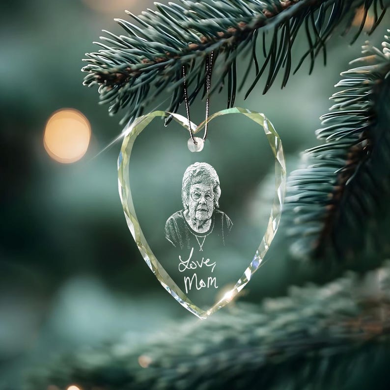 A beautiful memorial ornament, the Personalized Handwriting Memorial Heart Glass Ornament features custom engraved handwriting.