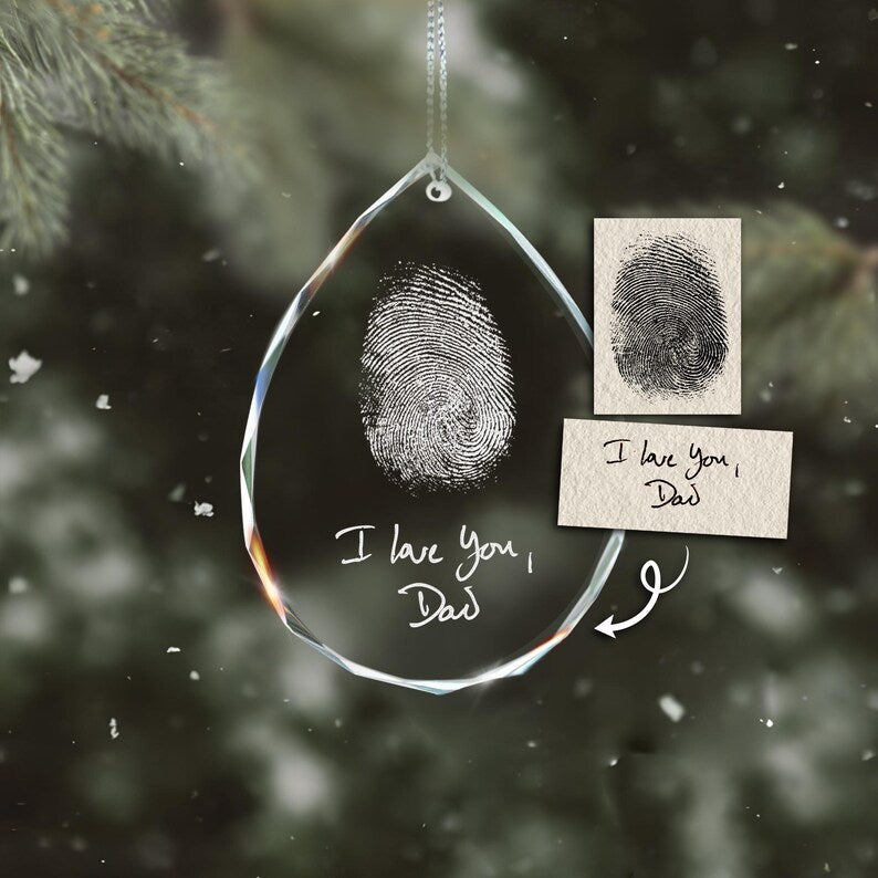 An elegant engraved Christmas ornament, the Personalized Teardrop Glass Ornament serves as a touching memorial fingerprint ornament.