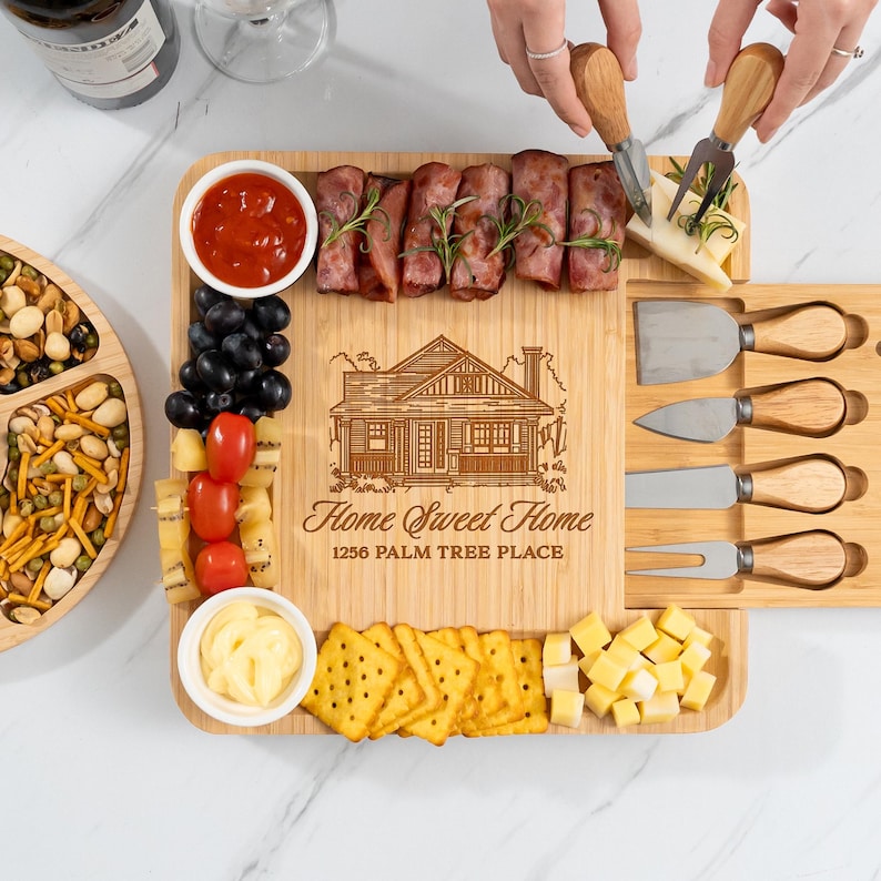 This personalized charcuterie board with tools, a Personalized Housewarming Bamboo Charcuterie Board, is a cherished housewarming gift idea.