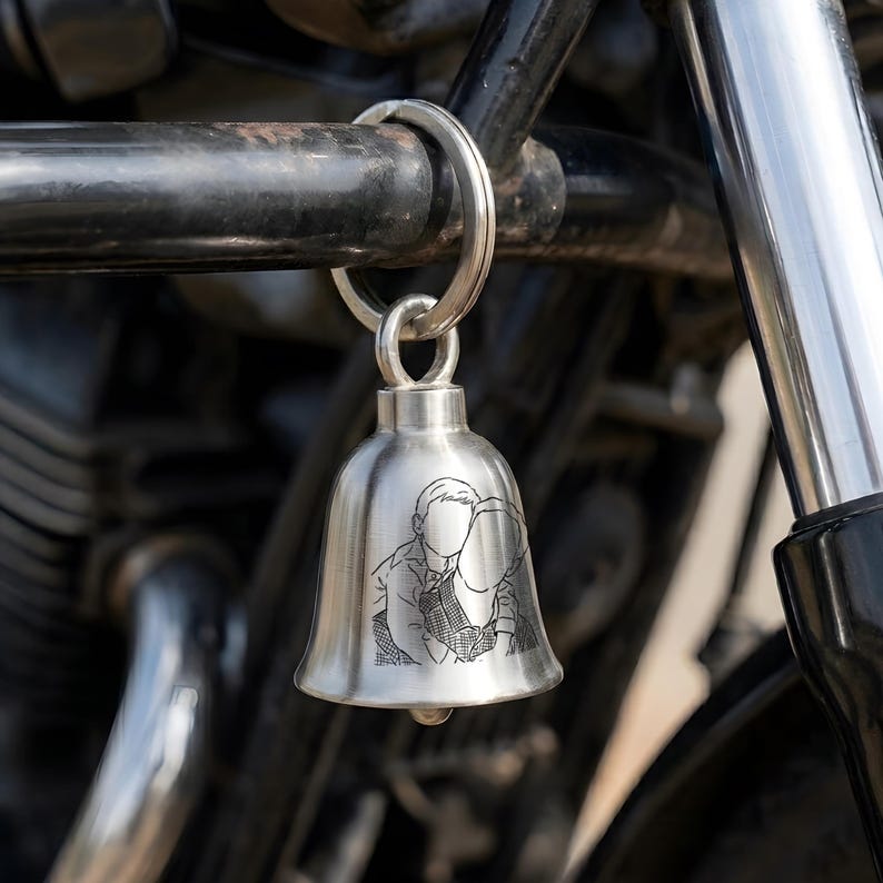 Custom engraved motorcycle guardian bell featuring a cross wing bell design and personalized line art.