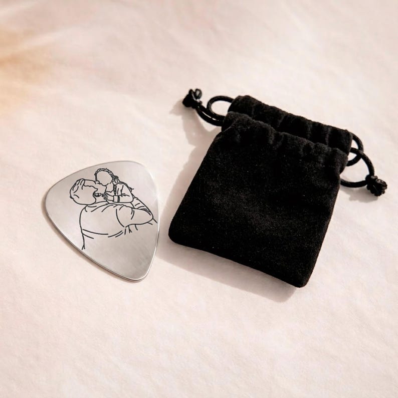 Custom line art portrait engraved on a guitar pick, a great Father's Day gift.