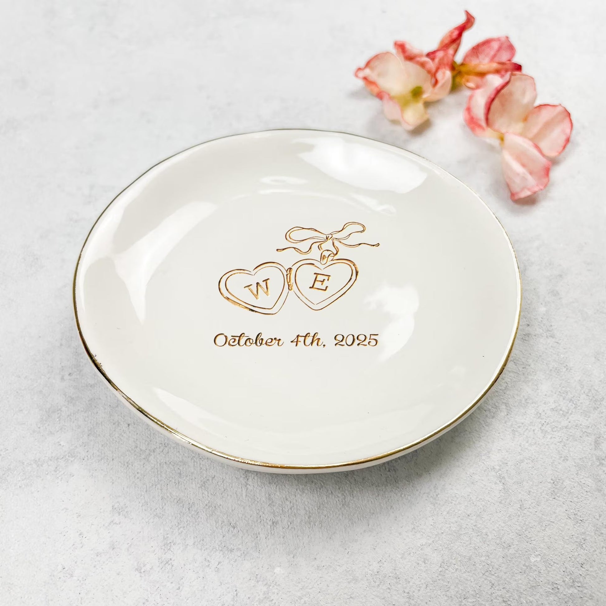 Wedding gifts for wedding couple include personalized ring holders with locket detail