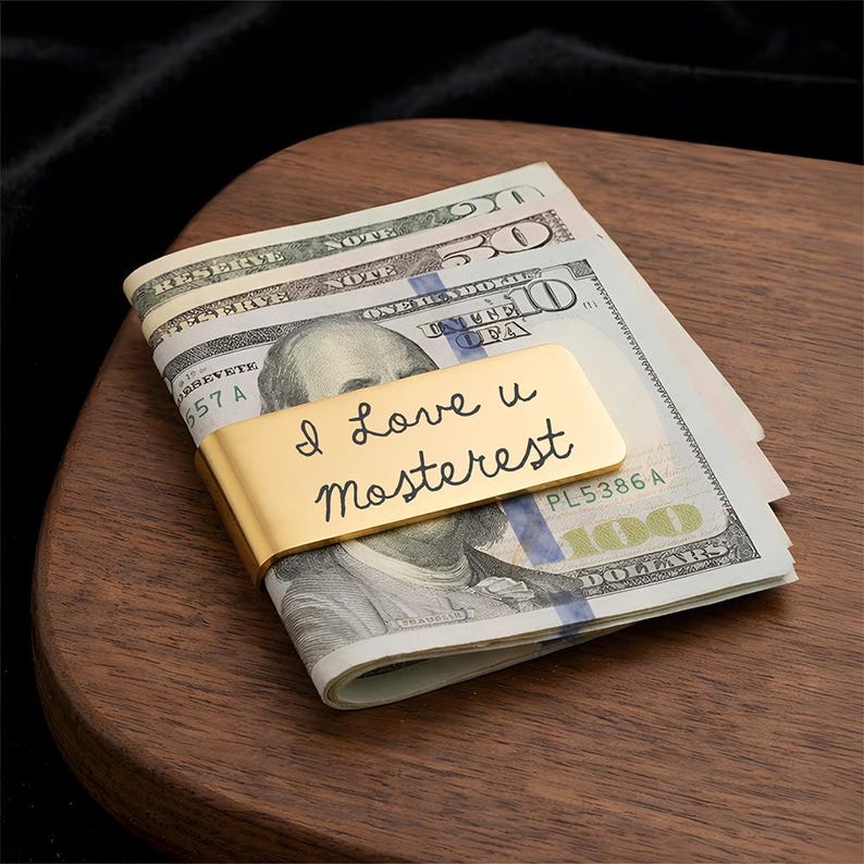 Custom stainless steel money clip engraved with a personal message, the best money clip for dad for Father's Day 2026.