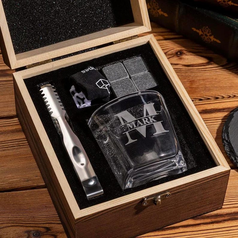 A close-up of a personalized whiskey glass and stone set, the Personalized Monogram Whiskey Set makes a great groomsmen gift.