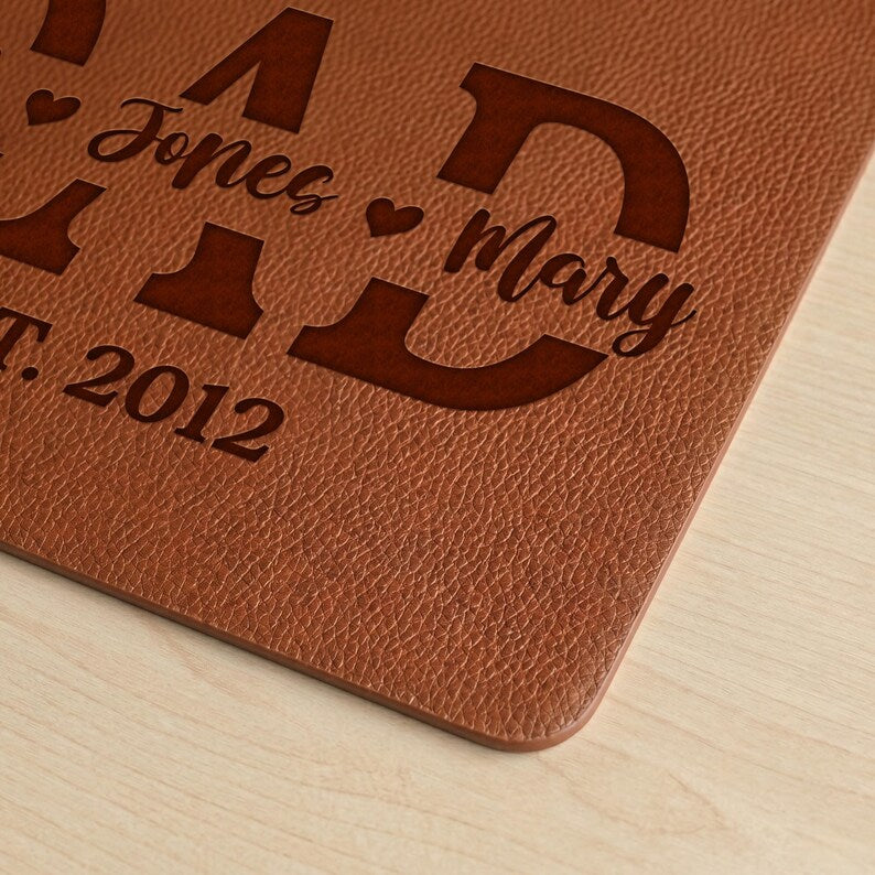 Leather desk pad custom engraved with family details, an ideal dad mouse mat and custom keyboard mat.
