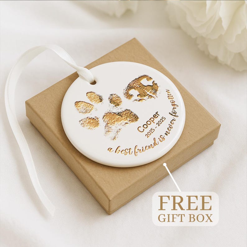 This ceramic Christmas tree ornament, a Personalized Paw and Nose Ceramic Ornament, is a custom dog paw ornament keepsake.