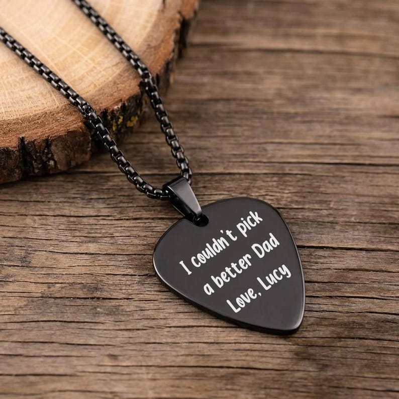 Engraved plectrum necklace and metal pendant, making a thoughtful Father's Day gift for guitar players.