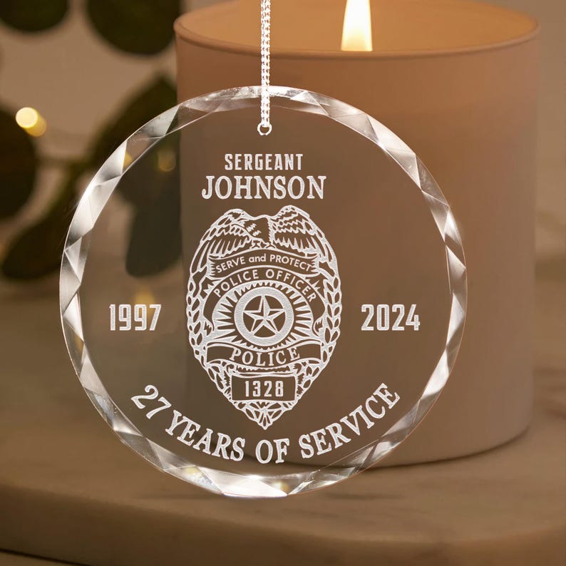 A close-up of a sparkling Personalized Police Retirement Glass Ornament, the ideal crystal ornament and police officer retirement gift.