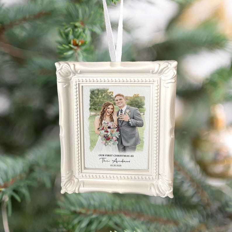 A close-up of a Mr. and Mrs. Christmas ornament, the Personalized Watercolor Photo Our First Christmas Frame Ornament is a cherished keepsake.